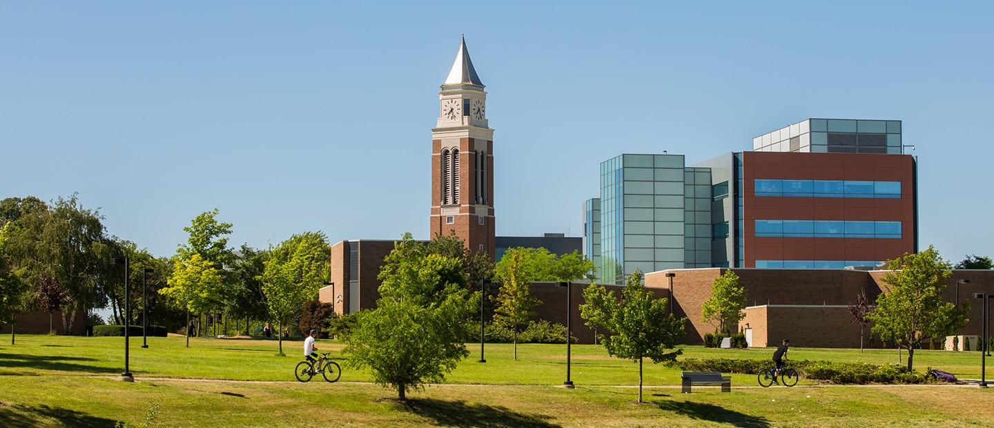 Elliott Tower and a blue glass and brown brick building on Oakland University's campus.